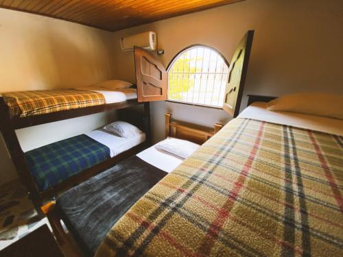 A bed or beds in a room at Tia Chela hostel