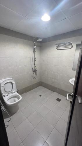 a bathroom with a toilet and a sink at BAITI Furnished Apartments in Salalah