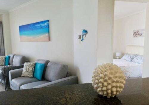 a living room with a couch and a table at 814 Shoal Bay Waterviews in Shoal Bay