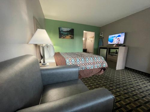 a hotel room with a bed and a flat screen tv at Travel Inn in South Lake Tahoe