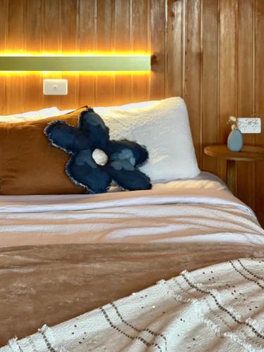 a blue teddy bear sitting on top of a bed at Kinoie Mornington - OCEANVIEW in Mount Martha