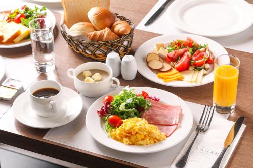 a table with plates of food on a table at Lahan Hotel Jeonju in Jeonju