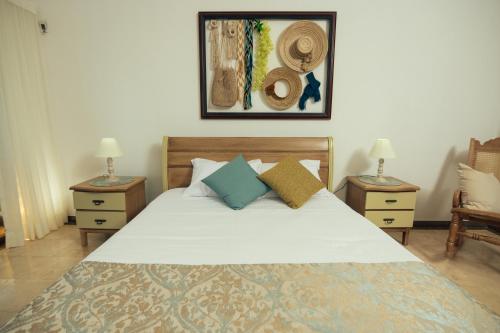 a bedroom with a large bed with two night stands at GUAJIRA CASA DEL MAR in Ríohacha