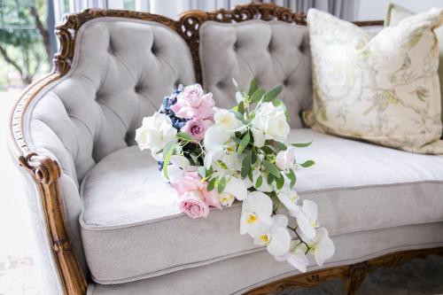a bouquet of flowers sitting on a couch at Burkleigh House in Johannesburg