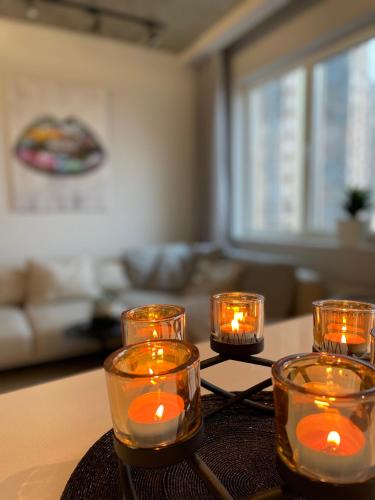 a group of candles on a table in a living room at Arcadia in Odesa