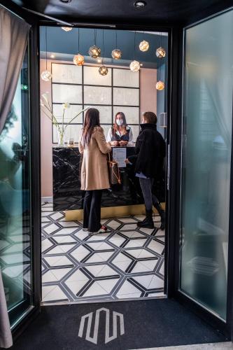 a group of people standing at a counter in a store at Navona Street Hotel in Rome
