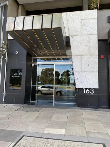 a building with a car in the front door at Modern, Quiet 1 Bed Apt on Fitzroy St, Opposite Albert Park in Melbourne