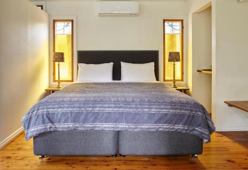 A bed or beds in a room at Ashwood Cottages