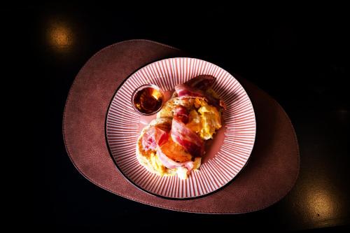 a plate of food on a table with a spoon at Navona Street Hotel in Rome