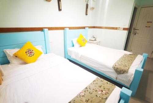 Postel nebo postele na pokoji v ubytování Shenzhen Xichong beach Lanting Homestay
