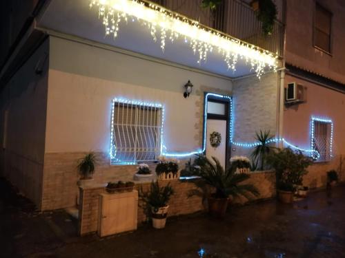 a house with christmas lights on the side of it at B&B Petra Hercules in Torre Annunziata