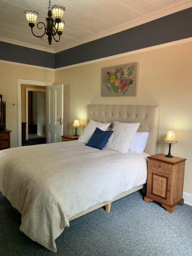 a bedroom with a large bed and a chandelier at Avon Terrace Guest House in York