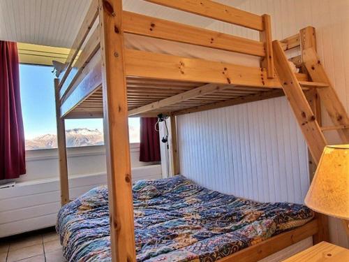 a bunk bed in a room with a window at Appartement La Plagne, 2 pièces, 5 personnes - FR-1-455-78 in La Plagne