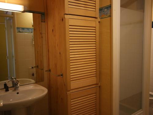 a bathroom with a sink and a toilet and a mirror at Studio Chamrousse, 1 pièce, 4 personnes - FR-1-549-64 in Chamrousse
