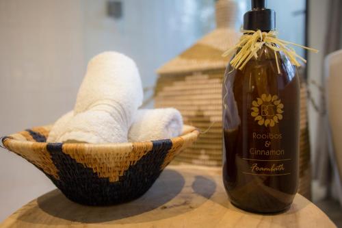 a basket with towels and a bottle of soap at Klaserie Drift Misava in Klaserie Private Nature Reserve