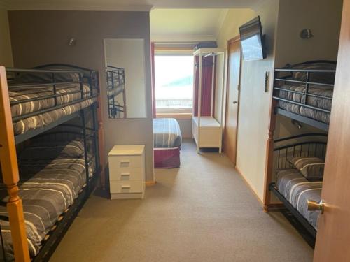a bunk bed in a room with two bunk beds at Cooroona Alpine Lodge in Falls Creek