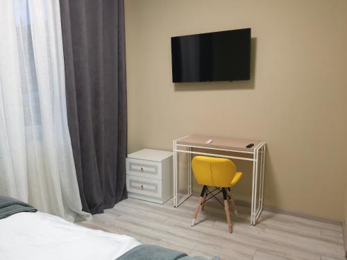 a bedroom with a desk and a yellow chair at Hotel Osher in Bukovel