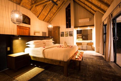 a bedroom with a large bed in a room at Klaserie Drift Misava in Klaserie Private Nature Reserve