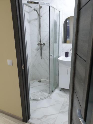 a bathroom with a shower and a sink at Hotel Osher in Bukovel