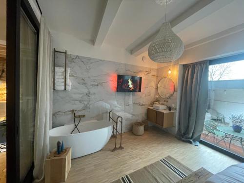 a bathroom with a white tub in a room at B&B Tholen t’Uusje in Tholen