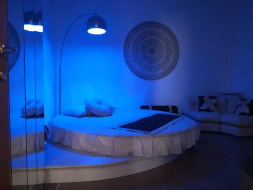 a blue room with a bed and a couch at Babbo maison in Guidonia