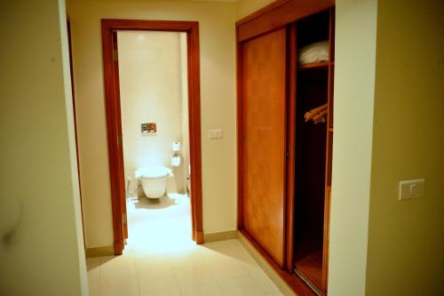 a hallway of a bathroom with a toilet and a door at Marina Sharm Hotel in Sharm El Sheikh
