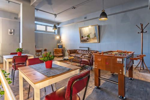 a living room with a table and a chess game at Bloom Hotel Rome in Rome