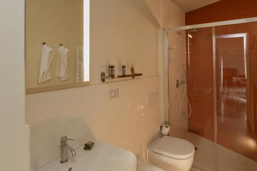 a bathroom with a toilet and a sink and a shower at Distilia Dimora Salentina in San Cesario di Lecce