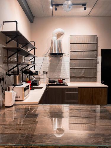 a kitchen with a counter top with a large appliance at Maison life 小居屋 The Loft Imago in Kota Kinabalu