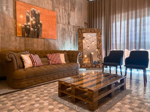a living room with a couch and a coffee table at Maison life 小居屋 The Loft Imago in Kota Kinabalu