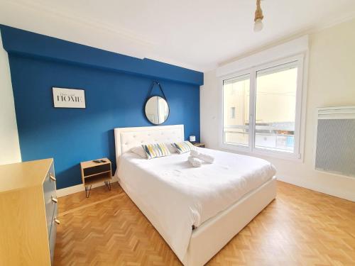 a bedroom with a blue wall and a bed at Résidence St Marc - Centre ville - WIFI in Quimper