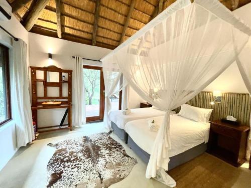 A bed or beds in a room at Rhino River Lodge