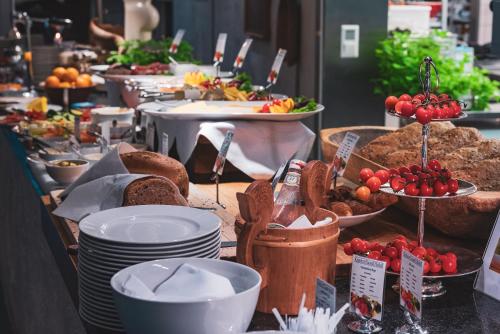 a buffet with plates of food on a table at Kronen Gaard Hotel in Sandnes