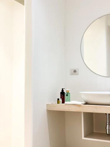 a bathroom with a sink and a mirror at Hotel Moresco in Santa Teresa Gallura