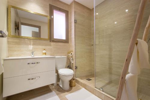 a bathroom with a toilet and a glass shower at Cocoon in PRESTIGIA GOLF & Wifi - FAMILLE in Marrakesh