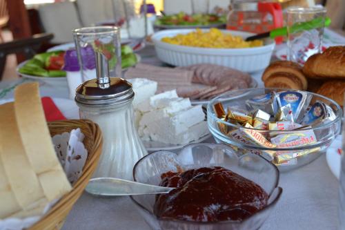 a table topped with bowls of cheese and other foods at Villa D&L in Ohrid