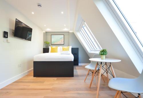 a bedroom with a bed in a attic at StayPrime Marylebone Serviced Apartments in London