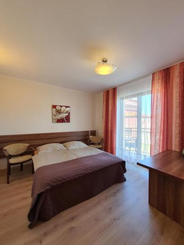 a hotel room with a bed and a window at Villa Amber in Międzywodzie