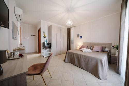 a bedroom with a bed and a desk and a television at Agriturismo Tenuta Don Carlo in Nocera Superiore