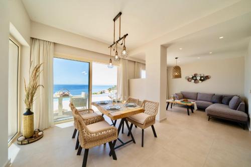 a living room with a table and chairs and a couch at Tsimaras Villas in Skala