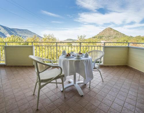 a table and chairs on a balcony with mountains at Agriturismo Tenuta Don Carlo in Nocera Superiore