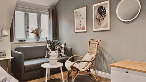 a living room with a couch and a chair at Hotel Marie in Skagen