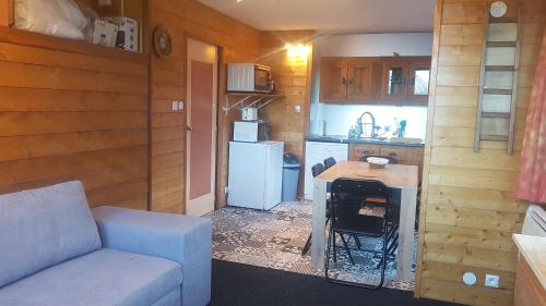 a small kitchen with a couch and a table in a room at Plagne centre -Pied de pistes in La Plagne Tarentaise