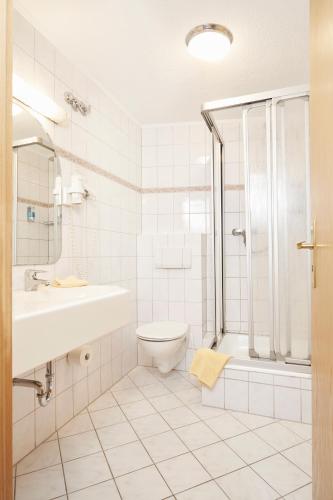 a bathroom with a sink toilet and a shower at Park Hotel Berlin in Bad Fallingbostel