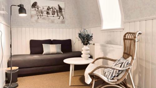 a living room with a couch and a table at Hotel Marie in Skagen