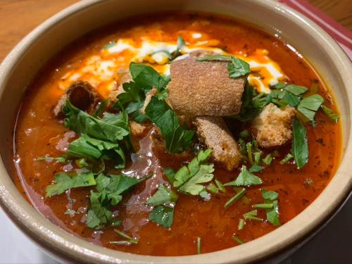 a bowl of soup with meat and vegetables in it at La Chanterelle - Mountain Lodge in La Côte dʼArbroz
