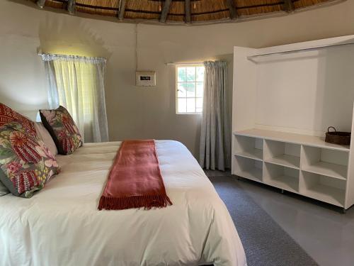 a bedroom with a large white bed and a window at Jock of the Bushveld in Barberton