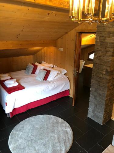 a bedroom with a large bed in a room at La Chanterelle - Mountain Lodge in La Côte dʼArbroz