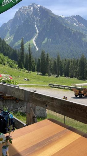 a view of a mountain with a train on a road at California House in Klosters