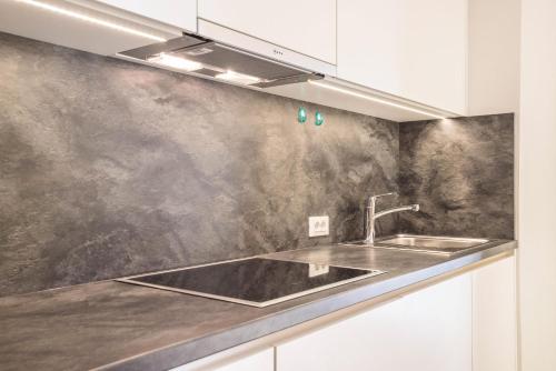 a kitchen with a sink and a counter top at Rosalpina Apt 3 in San Vigilio Di Marebbe